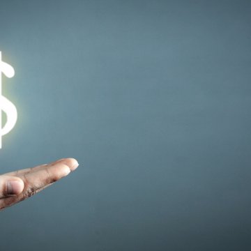 hotspot shield vpn services cost price man hand holding bright dollar sign